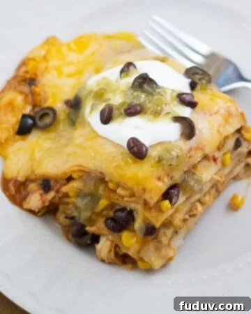 A square piece of Chicken Enchilada Casserole on a plate.