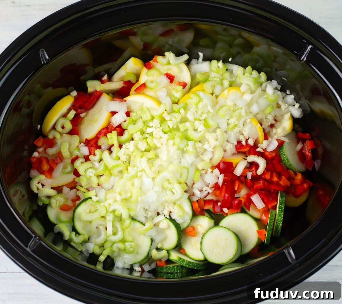 Sliced, diced and minced vegetables for a summer squash casserole.