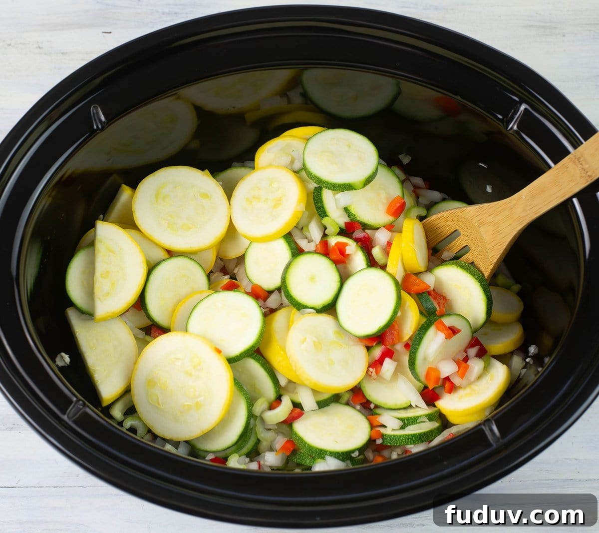 Mixing the vegetables to combine.