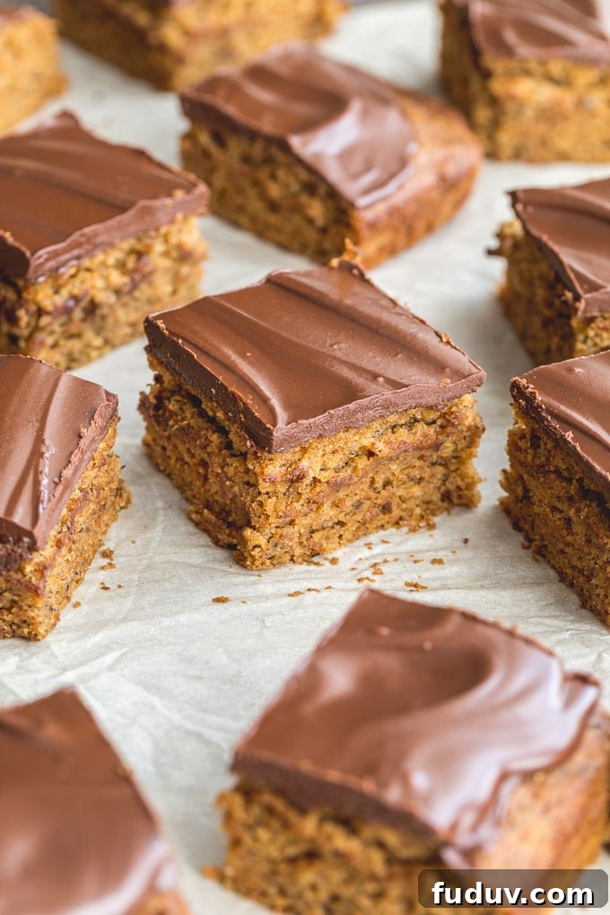 Squares of vegan banana cake arranged on parchment paper.