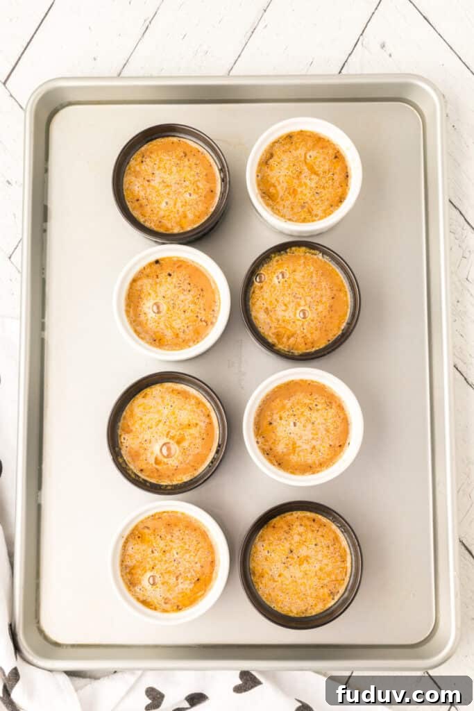 Unbaked Cappuccino Crème Brûlée ramekins arranged on a baking sheet