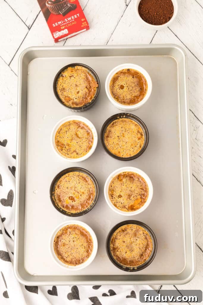 Baked Cappuccino Crème Brûlée custards cooling in ramekins on a baking sheet