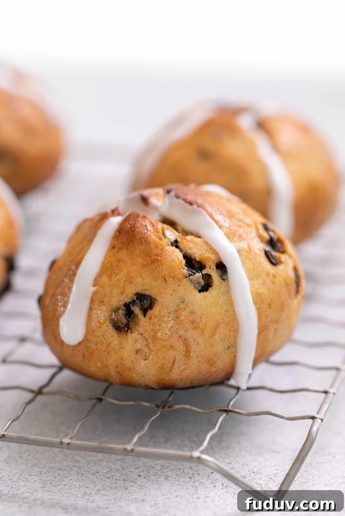 Hot cross buns with frosting crosses on wire rack