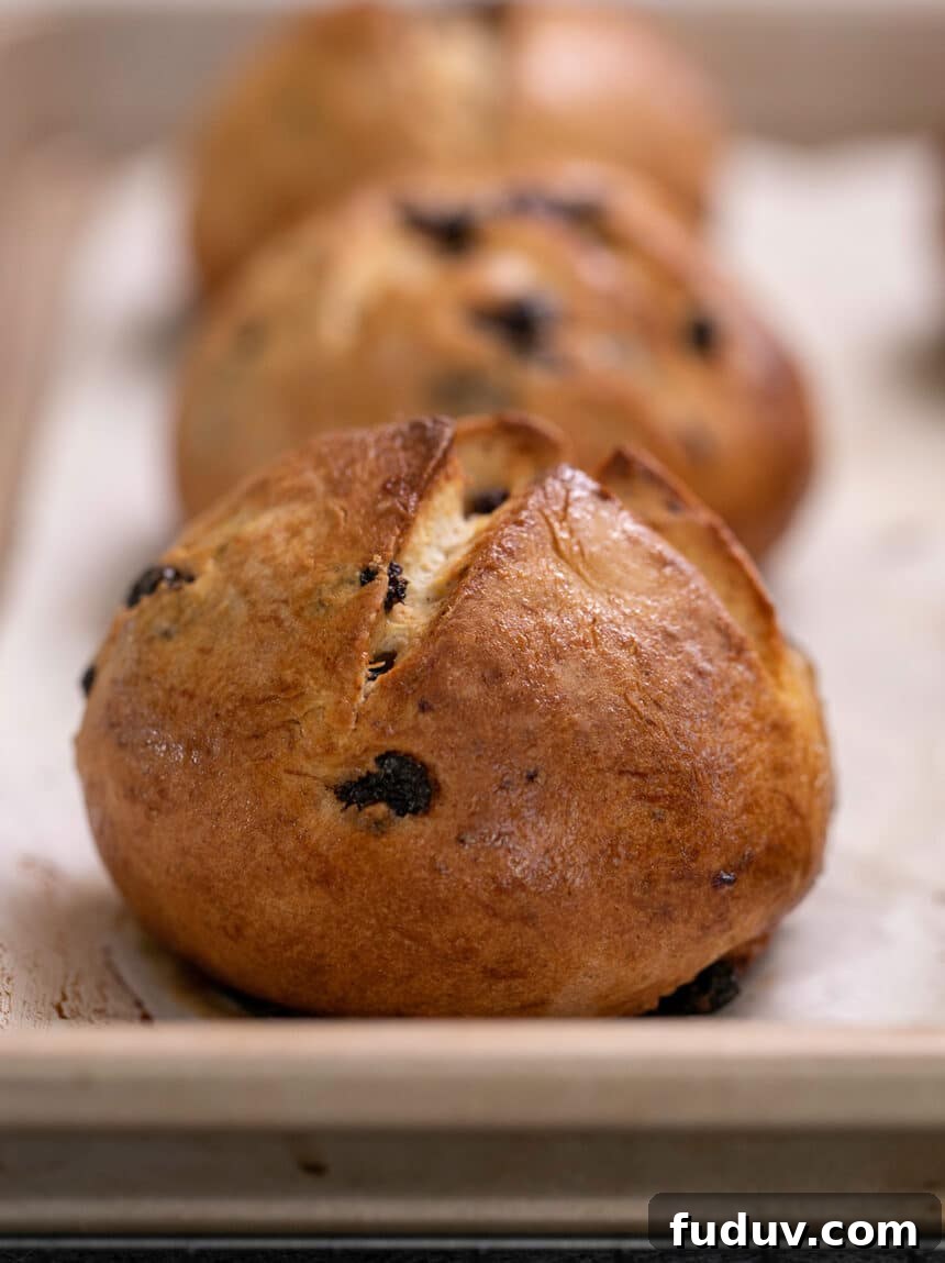 Hot cross buns baked on white paper on tray