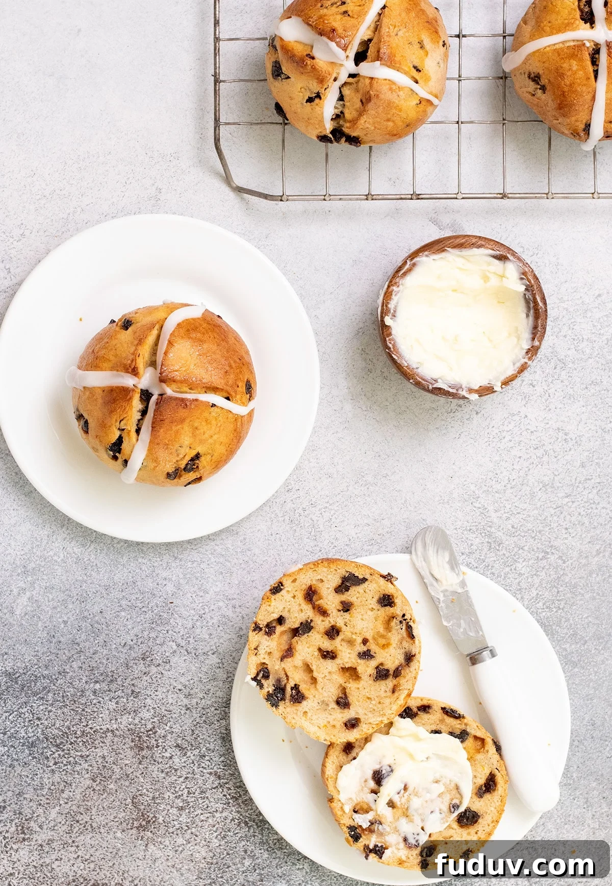 Overhead image of hot cross buns on wire rack, on small plate, and on small plate cut in half with butter