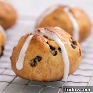 gluten free hot cross buns with white icing cross with raisins on wire rack