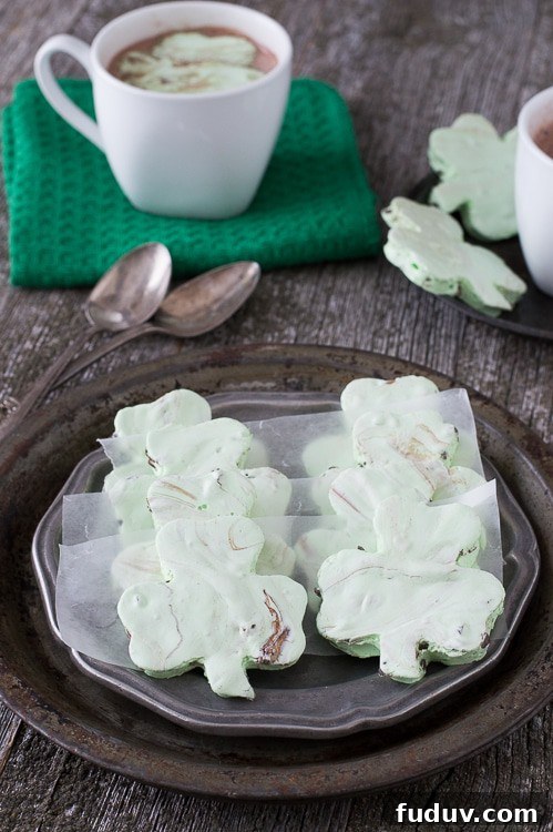 Mint Chocolate Chip Shamrock Marshmallows - a fun homemade marshmallow recipe for St. Patrick’s Day. These are so fun! Mint Chocolate Chip Shamrock Marshmallows on a serving plate.