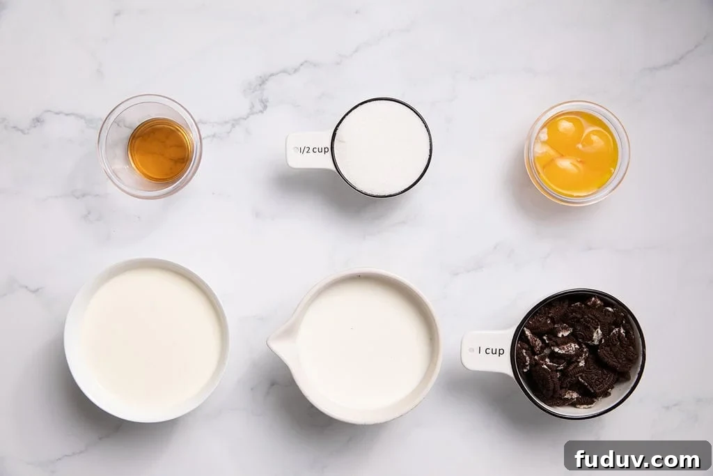 Ingredients laid out on a counter: egg yolks, milk, heavy cream, vanilla, sugar and oreo cookies
