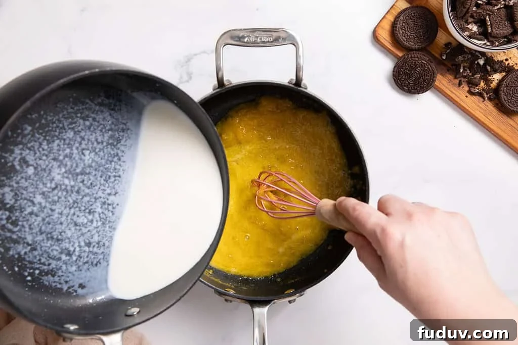 Egg yolks being tempered with warm milk.
