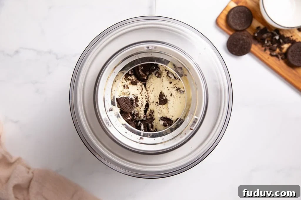 A churned cookies and cream mixture in an ice cream machine