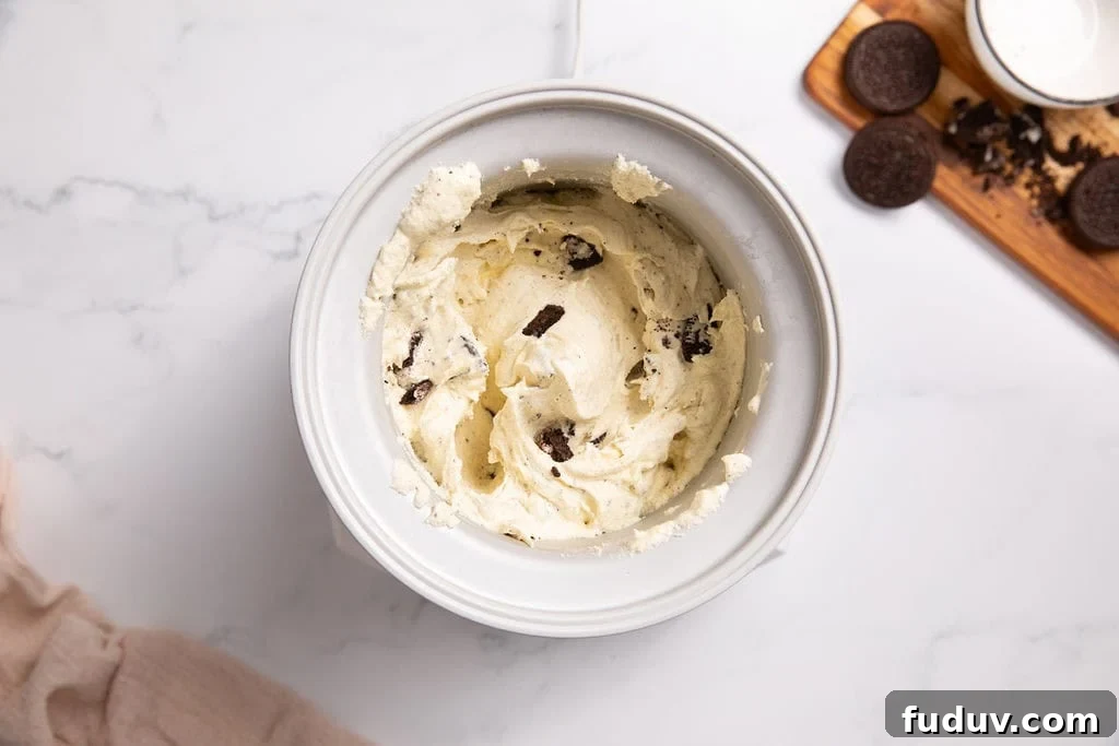 A churned cookies and cream mixture in an ice cream machine