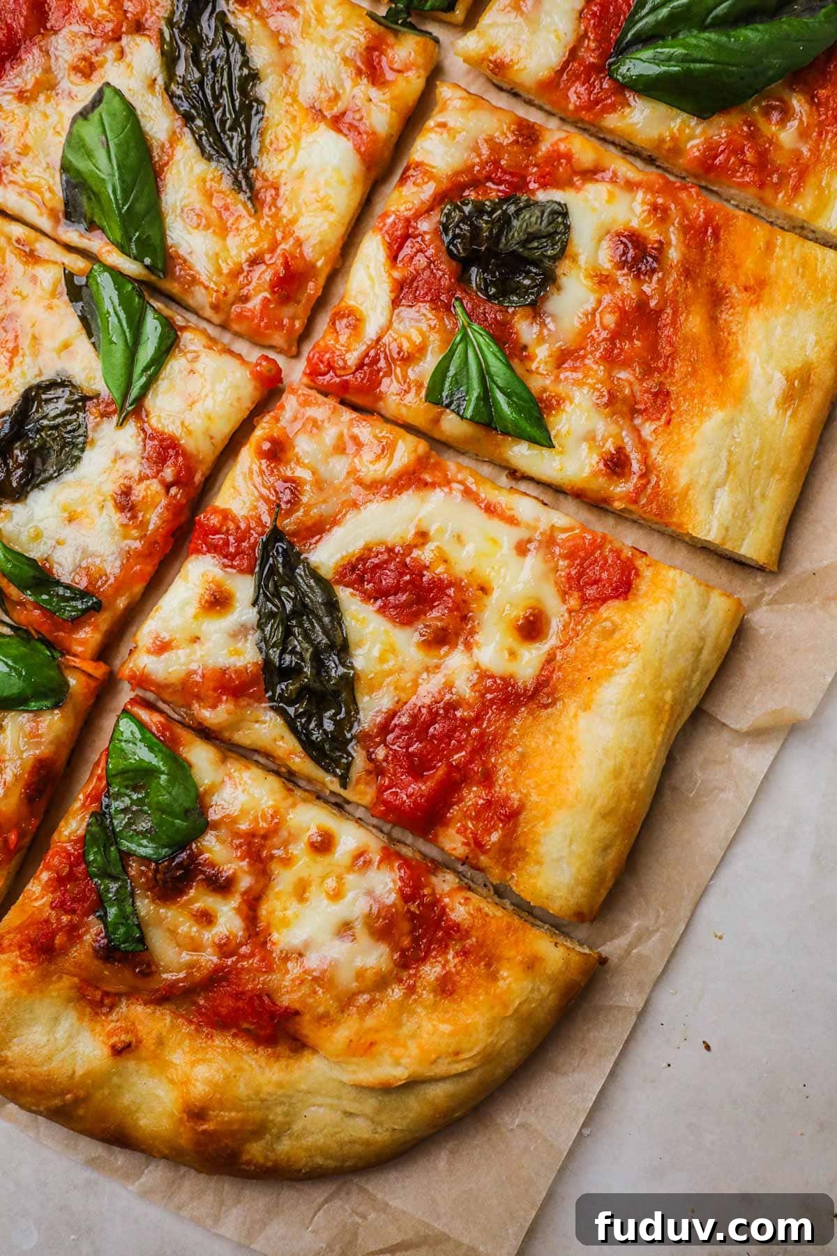 Homemade margherita pizza topped with authentic pizza sauce, mozzarella, and basil.