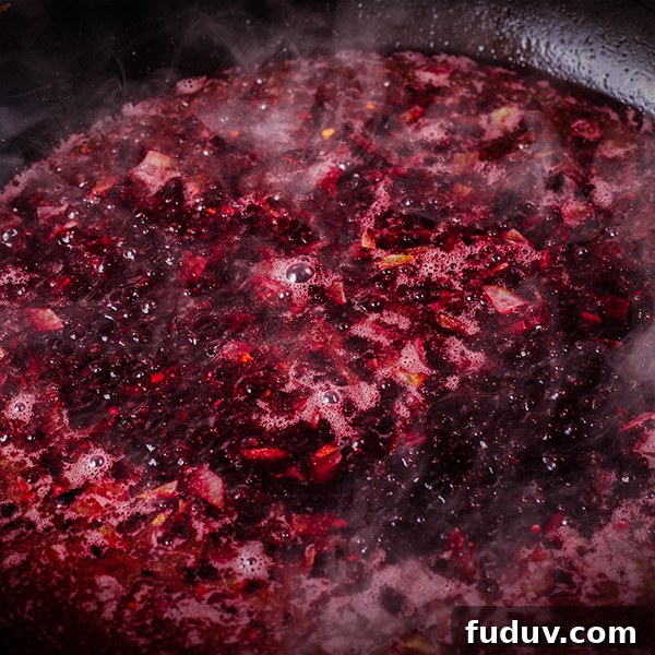 Red wine cherry sauce simmering in a skillet.
