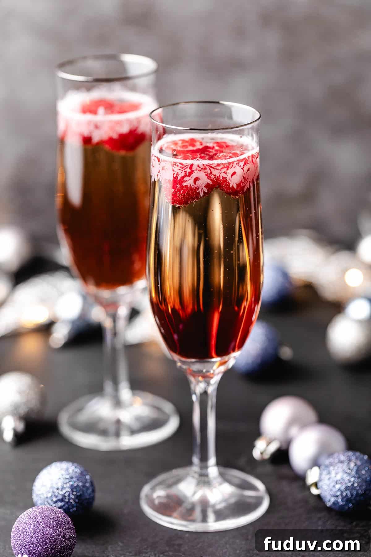 How to Make a Chambord and Prosecco Cocktail (Raspberry Fizz) 2 Side view of glasses of Chambord and Prosecco.