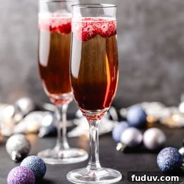 How to Make a Chambord and Prosecco Cocktail (Raspberry Fizz) 4 Side view of two glasses of champagne with raspberry liqueur.