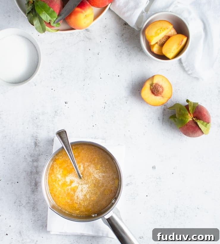 Small-Batch Bourbon Peach Jam Recipe for Preserving Summer Flavor 4 pan with peach jam cooking in it