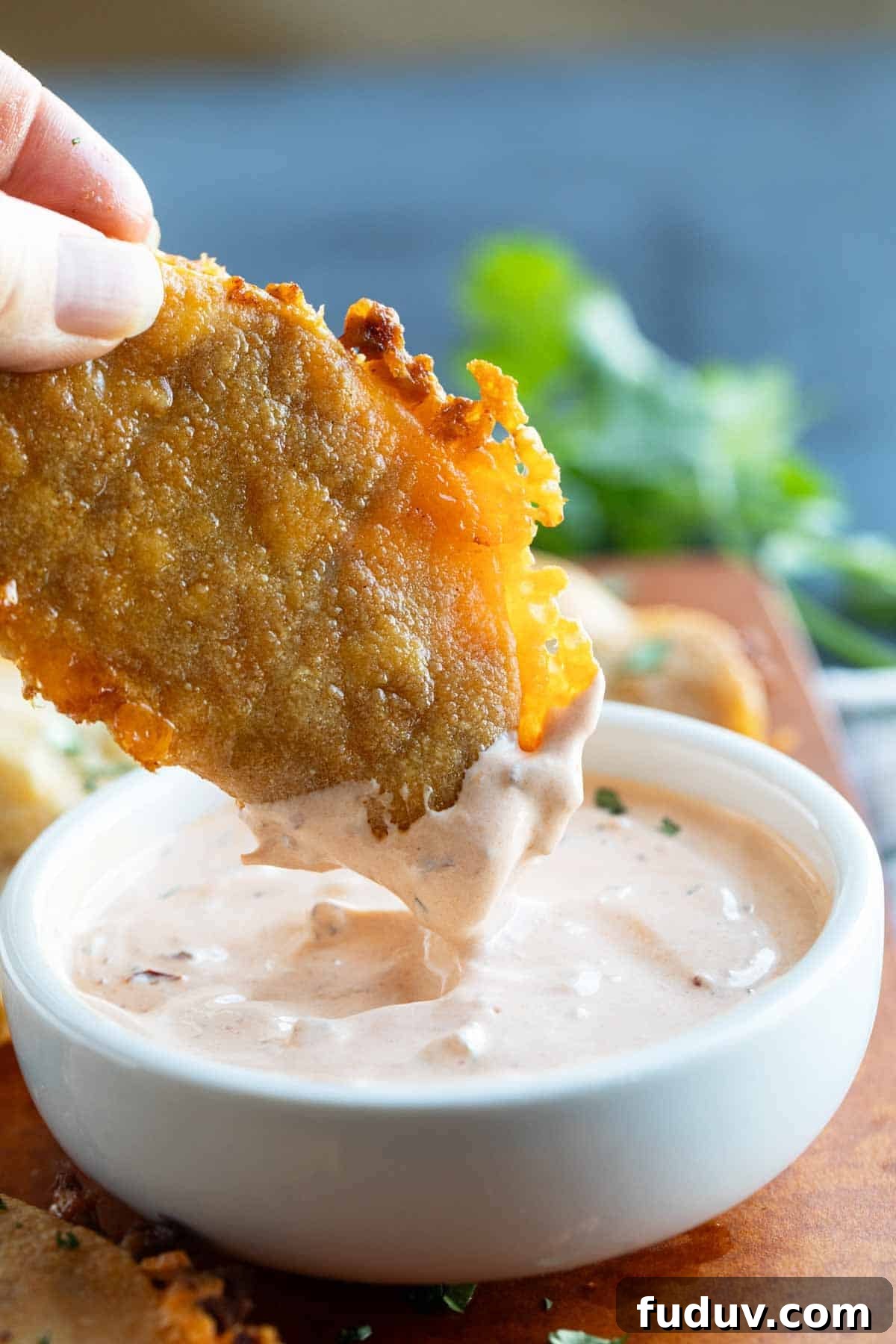Crispy Chicken Tacos with Tangy Slaw and Avocado crema 6 Dipping a Crispy Chicken Taco in creamy chipotle sauce.