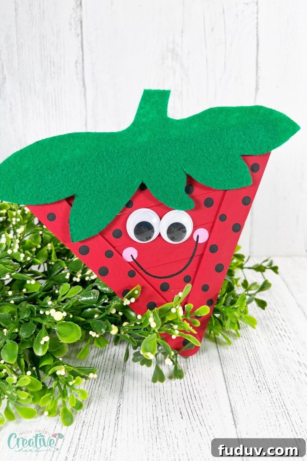 The simplicity of using jumbo craft sticks as the base structure makes this strawberry craft sturdy and easy to handle.