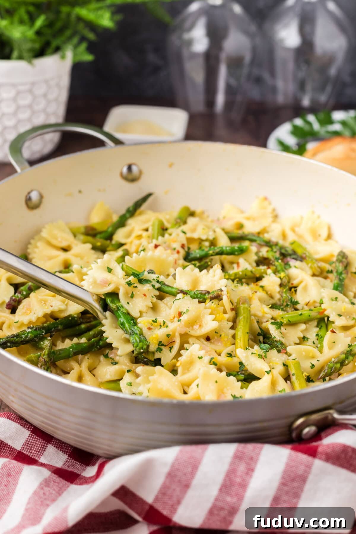 Spoon in a skillet of Asparagus Pasta