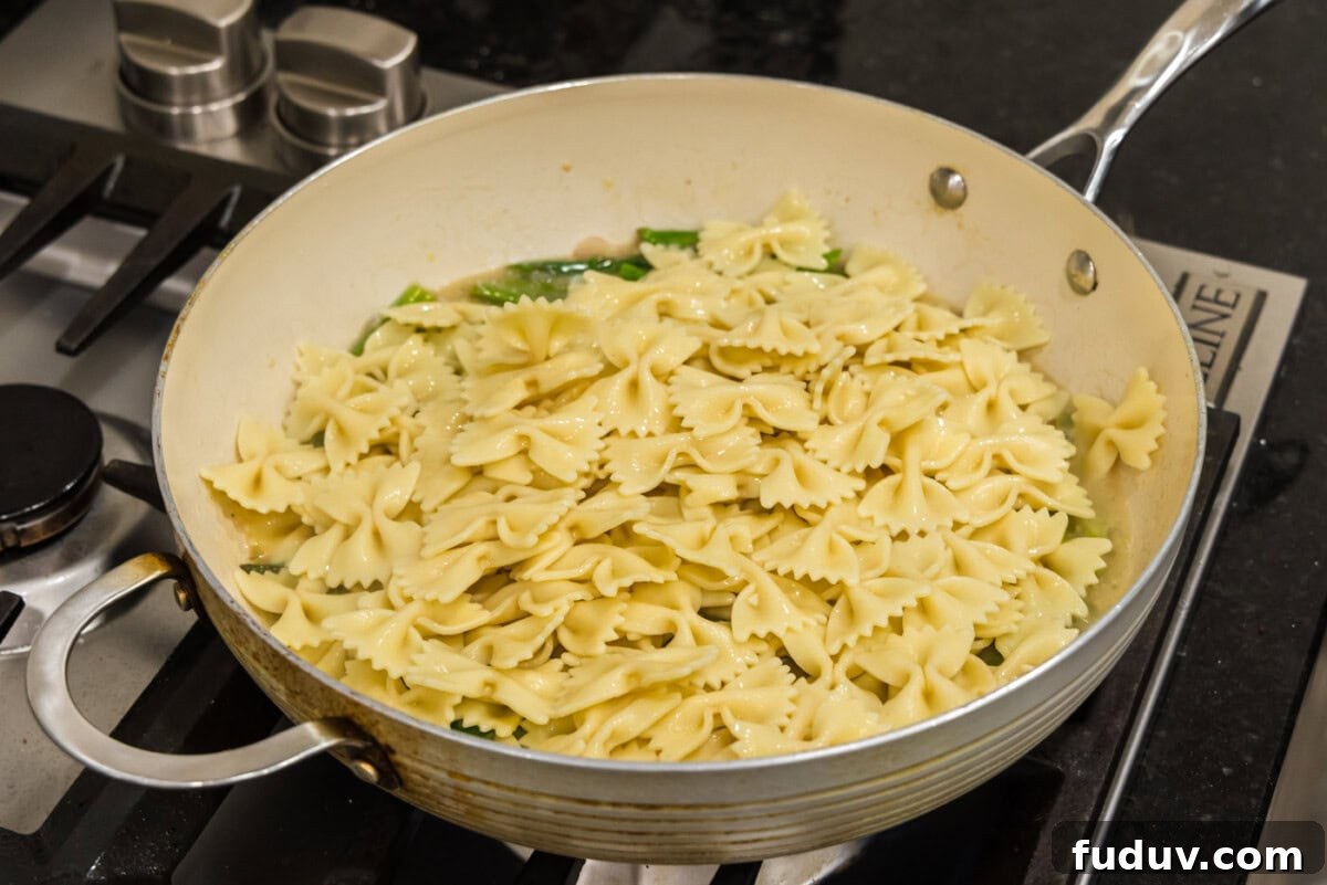 bowtie pasta added to buttered asparagus sauce