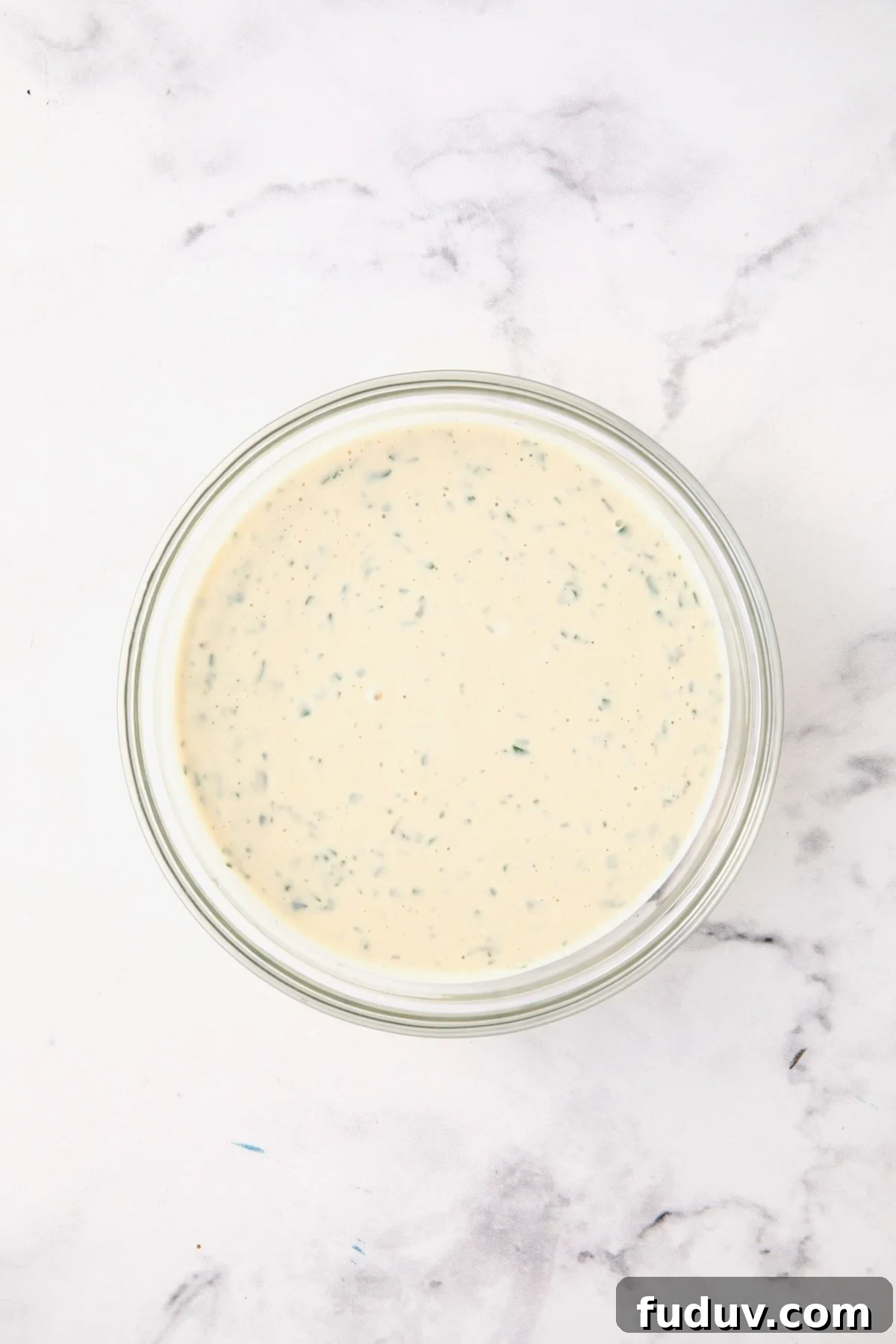 Dressing for chicken salad in glass bowl.