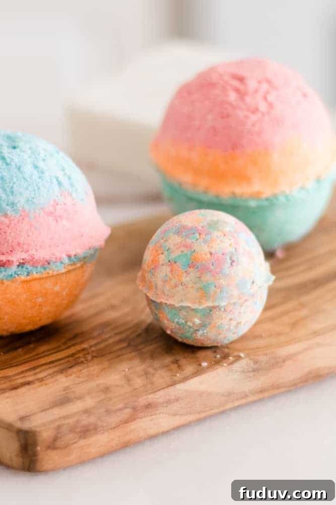 Rainbow bath bombs for kids on wood board.