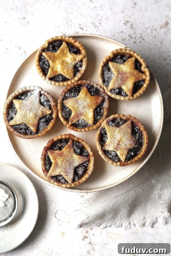 Plate of mince pies dusted with icing sugar.