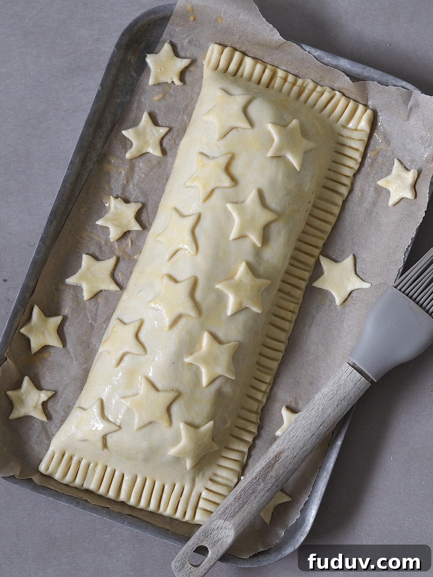 Brushing the pastry with egg mixture and adding decoration